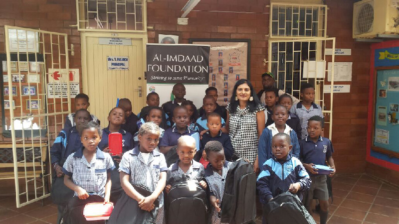 A happy school representative with beneficiary learners from the school